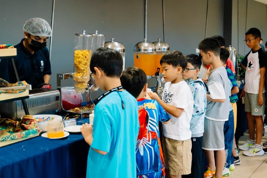 Campers queueing at the buffet in the school dining hall at Epsom College Malaysia