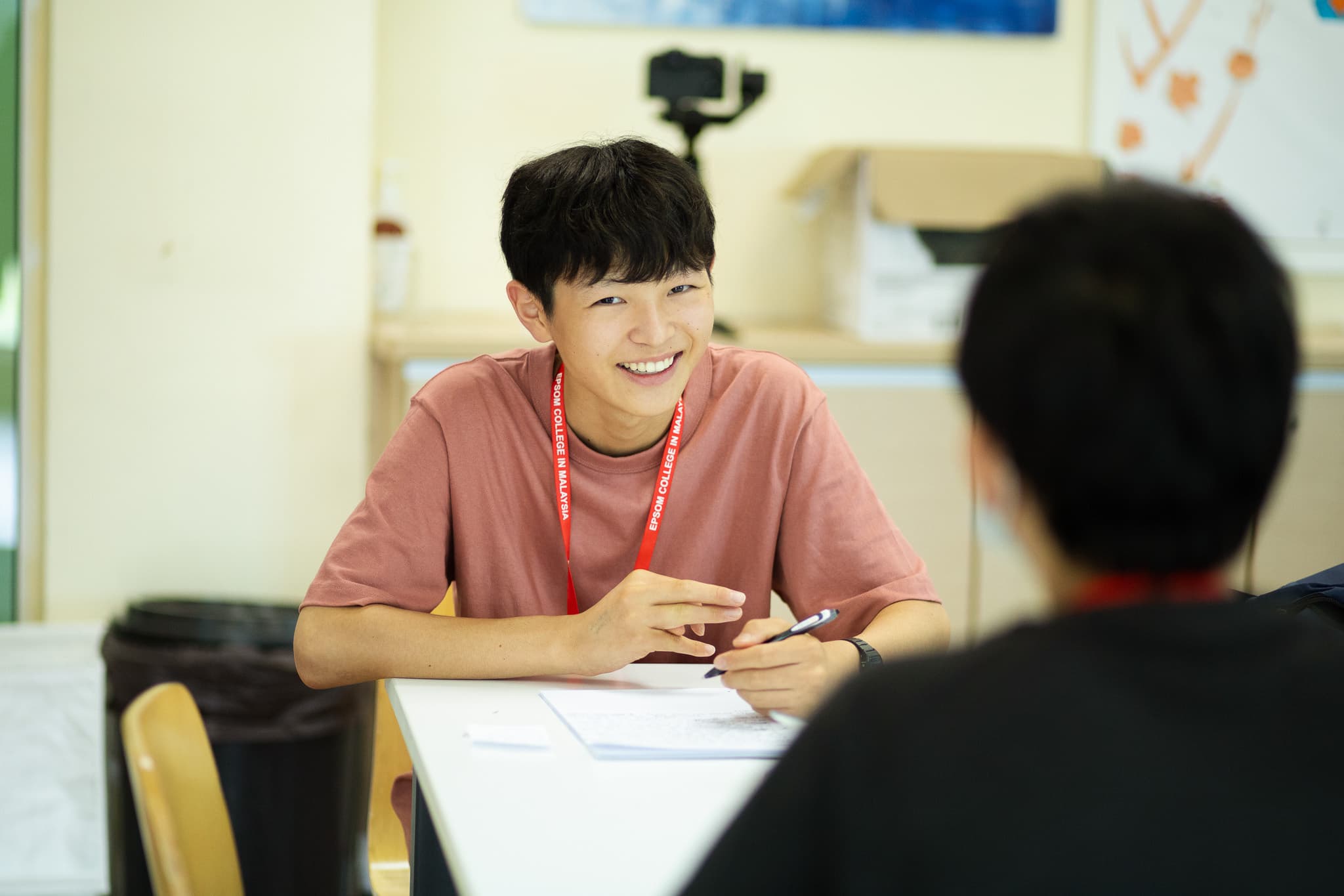 A teacher helping one camper with their work