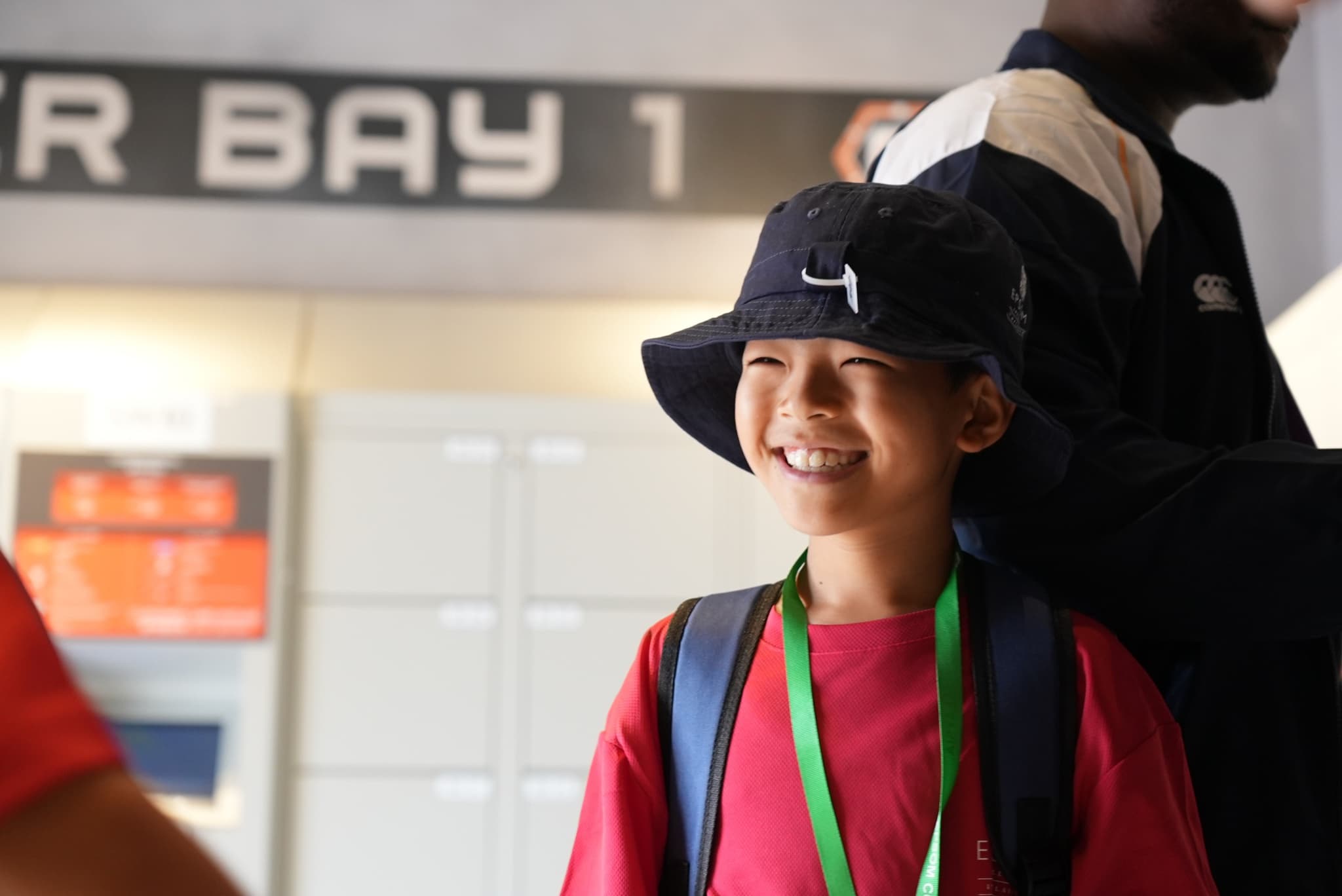 A camper being met by staff at Kuala Lumpur International Airport